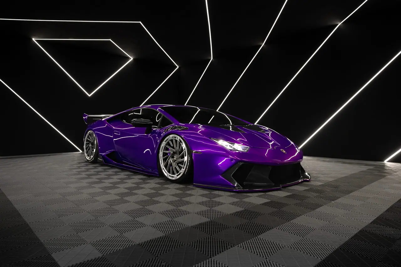 Purple Lamborghini Huracán on Aphero AF-3 wheels in a dark studio with light bars